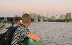 two students overlooking charles river