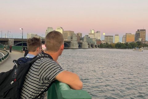 two students overlooking charles river