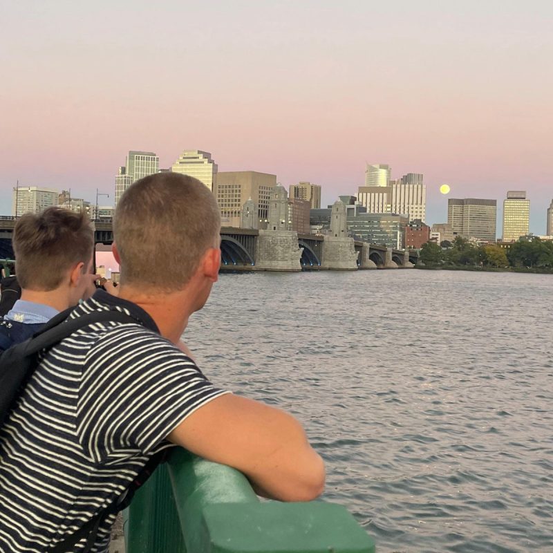 two students overlooking charles river